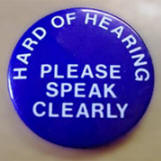 badge asking people to speak clearly